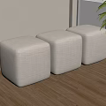 Three Beige Square Fabric Stools On Wooden Floor Near Window With Green Plant