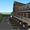 Red Brick Commercial Street With Clock Tower Arched Entrance And Pedestrian Activity