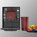 Black DeLonghi Coffee Machine With Red Cup And Fresh Fruit Platter In Kitchen