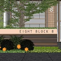 Modern Feature Wall With EIGHT BLOCK 8 Signage And Lush Bushes By Building Entrance