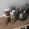 Kitchen Utensils Organized on Wooden Shelves with Black Jug Glass Jars Spices Mortar and Bowls