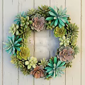 Succulent Wreath Decor with Mixed Green Pink Plants Hanging on White Wooden Wall