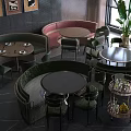 Green And Pink Banquette Sofas In Restaurant Interior With Round Tables And Chairs