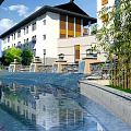 Tranquil Garden Landscape With Modern Building Water Reflections Bamboo And Stone Lanterns