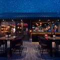 Elegant Bar Interior With Wooden Ceiling Decor Leather Seating And Warm Ambient Lighting