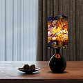 Vibrant Table Lamp With Colorful Autumn Leaf Pattern Shade On Wooden Table And Pine Cones