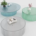 Modern Round Transparent Coffee Tables With Blue Green Clear Colors Featuring Plants Vase Books Cups
