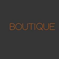 Green Neon Decorative Light With BOUTIQUE Text On Dark Blue Background