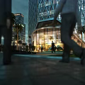 Modern Urban Night Landscape With Illuminated Glass Buildings Palm Trees And Pedestrians Walking