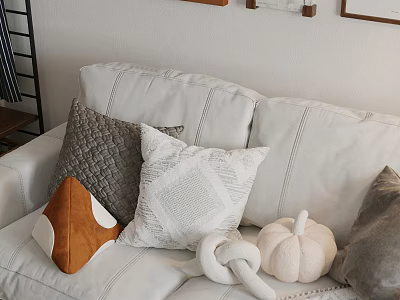 Cozy Textured Pillows On White Sofa With Orange Accent And Decorative Pumpkin 3d model