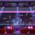 Modern KTV Interior Design With Purple Lighting Sofas Bar Counter And Wine Bottles