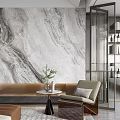 Modern Leisure Chair In Living Area With Marble Wall And Green Plant On Side Table