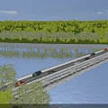 Bridge With Cars Driving Over River Surrounded By Green Trees And Grassy Banks