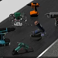Various Electric Power Tools Displayed on Wooden Table Including Drill Sander Glue Gun