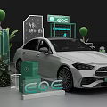 White Mercedes EQE Electric Vehicle Display With Green Plants And Brand Signage
