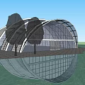 Modern Arched Glass Building With Metal Frame Under Blue Sky And Hexagonal Pavement