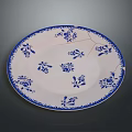 Sculpture Carving On White Plate With Blue Floral Patterns And Decorative Edge