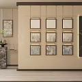 Nine Gold Framed Landscape Paintings On Beige Wall With Green Plant And Dark Decorative Panel