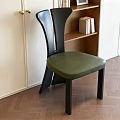 Modern Black Backrest Dining Chair With Green Seat White Cabinet Bookshelf And Wooden Floor