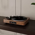 Vintage Turntable With Black Vinyl Record On Wooden Table Near Green Plant And Lamp