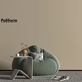 Green Velvet Bean Bag Chair In Modern Interior With Side Table And Decorative Pillow