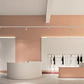 Modern Clothing Store Interior with Peach-Colored Walls White Counter Clothes on Hangers and Spotlights