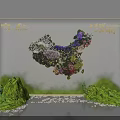 Floral Art Installation With Mixed Purple White Red Blooms Green Foliage And Stone Pebbles