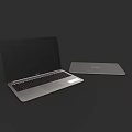 Sleek Modern Silver Open And Closed Laptops On Dark Background