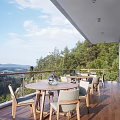 Home Balcony Featuring Wooden Flooring Glass Railing Mountain View Green Trees Round Table Light Chairs