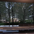 Modern Residential Landscape With High Rise Building Trees Lawn Glass Structure Pathway And Evening Lighting