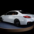 White Luxury Sedan With Modern Design Parked On Circular Display Platform 3d model