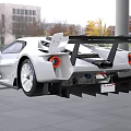 Sleek White Race Car With Aerodynamic Design Black Stripes And Stylish Front Headlights