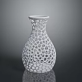 Green Plants In White Perforated Vase With Hollow Out Design On Black Surface