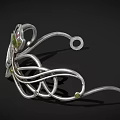 Elegant Silver Tiara Featuring Curved Design Floral Motif And Green Gemstone Inlaid