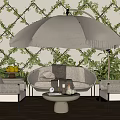 Outdoor Wicker Sofa with Accent Chairs Round Coffee Table Fringed Umbrella and Green Vine Wall