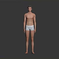 Shirtless Fit Man Standing In Light Colored Underwear Against Gray Background