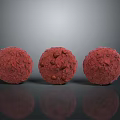 Three Delicious Red Food Balls with Textured Surface and Nutty Bits