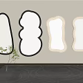 Various Shaped Mirrors Hanging On Wall In Interior With Carpet And Plant