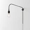 Modern Black Curved Arm Wall Lamp with Transparent Filament Bulb Mounted on White Wall