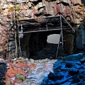 Scenic Rocky Cave Entrance With Metal Framework And Snow Covered Ground