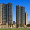 High Rise Residential Buildings Featuring Modern Exterior And Surrounding Greenery And Roads