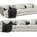 Modern Light Colored Three Seater Sofa With Cushions And Throw Blanket 3d model