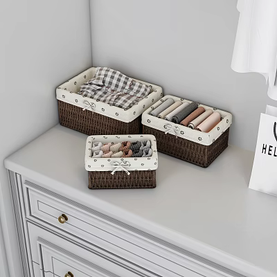 Brown Storage Baskets with White Trim on White Dresser Holding Folded Clothes 3d model