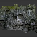 Ancient Buddha Stone Carvings on Cliff Wall with Moss Covered Rock and Natural Setting