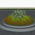 Circular Flower Bed Planter With White Yellow Orange Blooms And Stone Edge