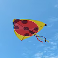 Vibrant Ladybug Kite Flying High In Blue Sky With White Clouds 3d model