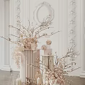 Elegant Floral Arrangement With Branches Cylinder Vase And Small Cake On White Sculpted Wall Background