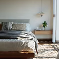 Minimalist Bedroom Interior With Cozy Bed Pillows Wooden Nightstand And Natural Light