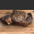 Juicy Roasted Meat Chunk on Wooden Cutting Board with Crispy Crust