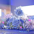 Dreamy Floral Decoration Setup With Blue Pink Flowers And Illuminated Backdrop